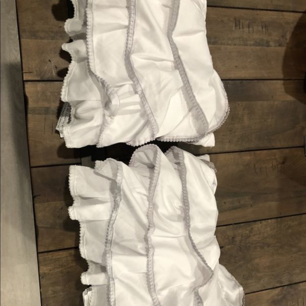 White ruffle trim pillow with grey trim